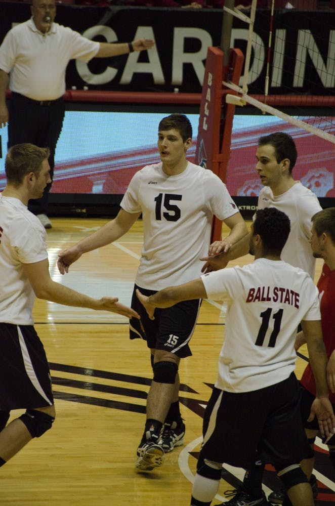 Sophomore outside attacker Marcin Niemczewski joins his celebrating teammates after getting a point against Loyola on Feb. 20 at Worthen Arena. Ball State lost 3-1. DN PHOTO. AUDREY ADDINGTON