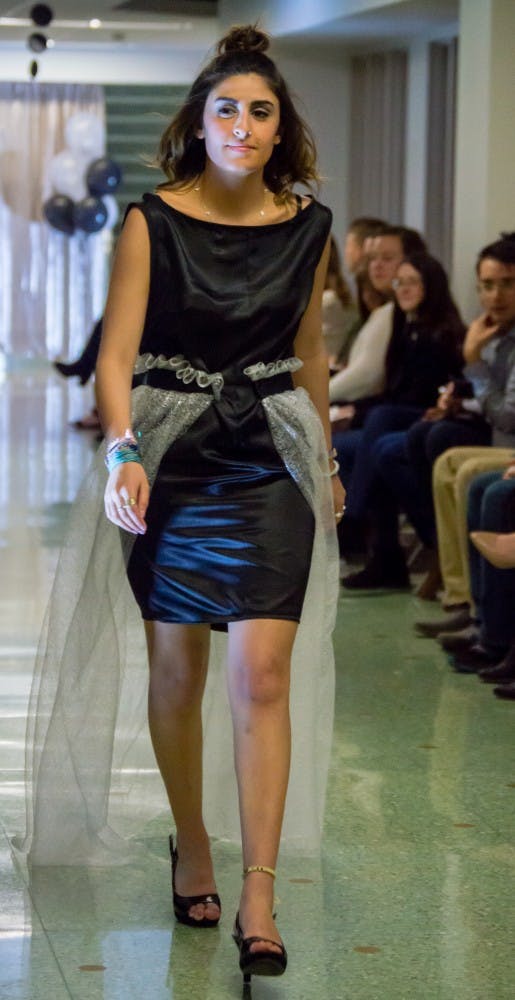Family and friends watched the Fashion Design Soceity host a fashion show on April 1 in the Applied Technology Building. Since 1997, the organization helps fashion students develop their skills. Teri Lightning Jr., DN