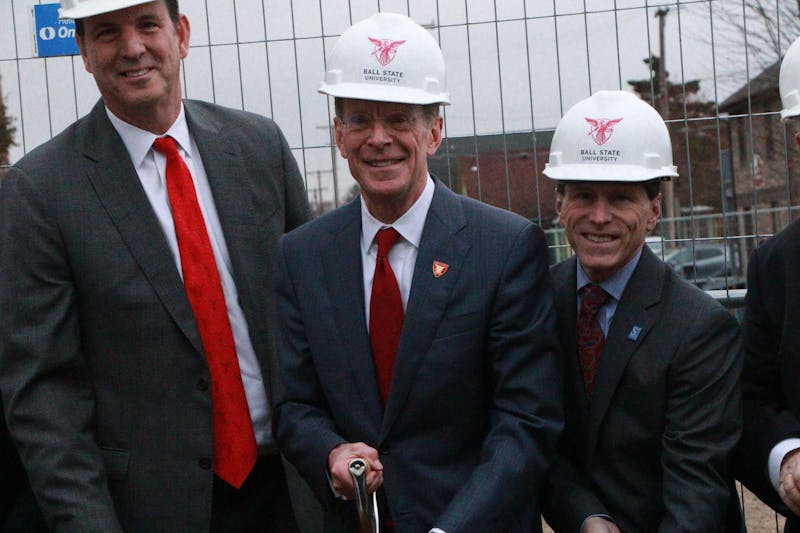 Rick Hall, Geoffrey Mearns and Greg Schahet stand side-by-side to commemorate the groundbreaking ceremony of a new performance arts center and Cantio Hotel in Muncie Ind.'s collegetown Village Nov. 14 with an official digging. The three men played vital roles in the planning of the project. Shelby Anderson, DN