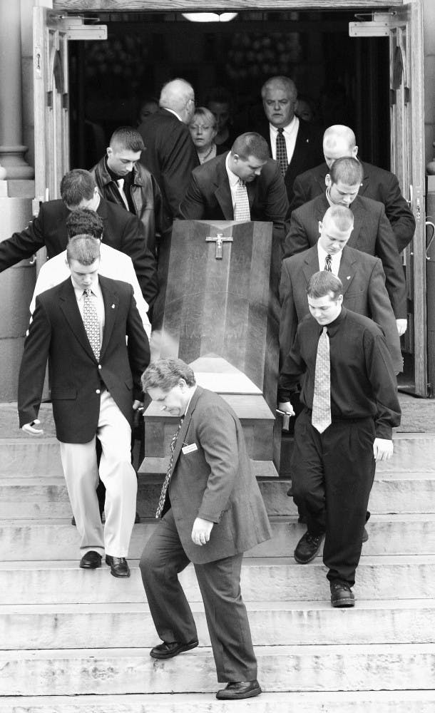 Pallbearers carry Michael McKinney