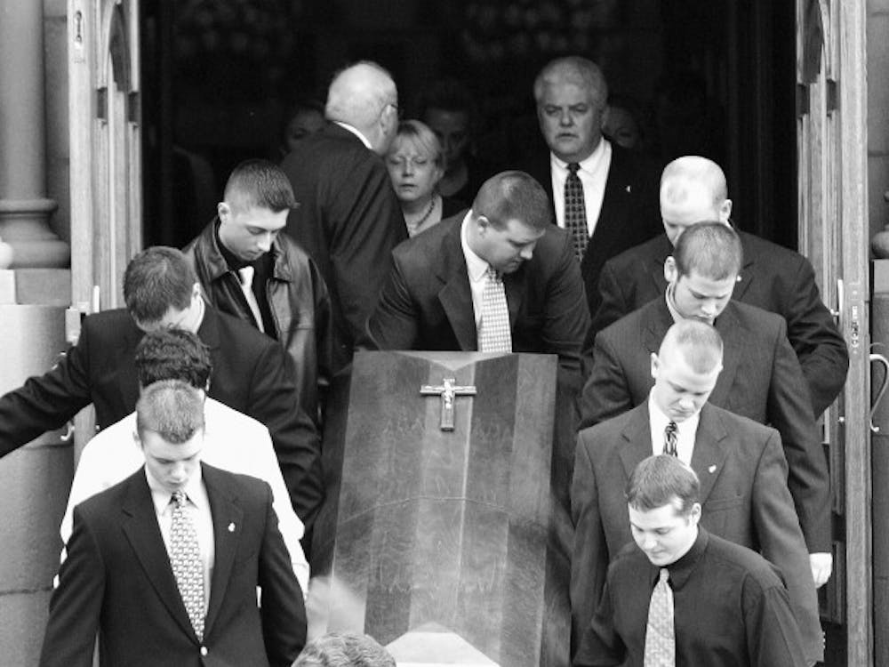 Pallbearers carry Michael McKinney