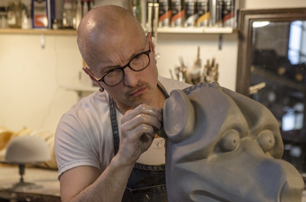 Jonathan Becker carves a clay mold at his studio in Muncie March 25 that will eventually be cast and become a mask. J.A. Fields, DN