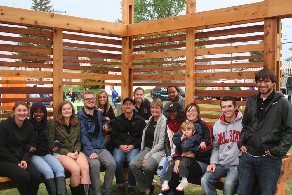 Architecture students sit with professor Pamela Harwood in the Maring-Hunt Community Garden, Spring 2017. Harwood received an award for her leadership of the immersive learning course that designed the garden near Maring-Hunt library. Pamela Harwood, Photo Provided