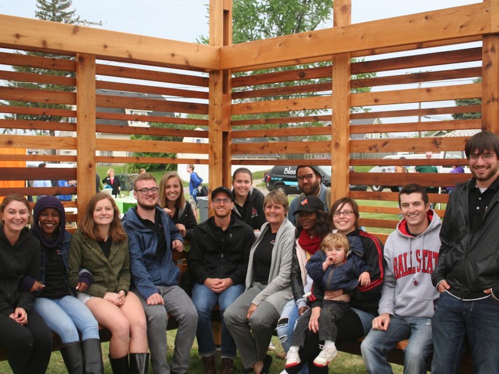 Architecture students sit with professor Pamela Harwood in the Maring-Hunt Community Garden, Spring 2017. Harwood received an award for her leadership of the immersive learning course that designed the garden near Maring-Hunt library. Pamela Harwood, Photo Provided