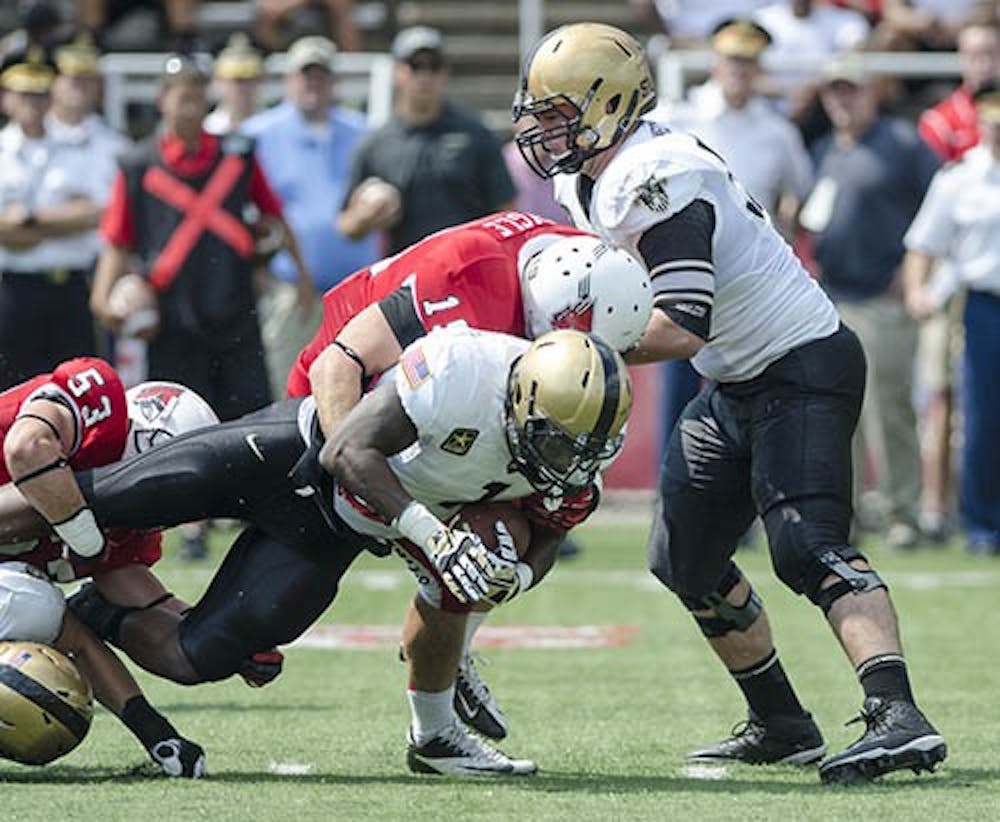 Ball State linebacker Ben Ingle goes for the sack against Army in the third quarter of the game on Sept. 7. Ball State would overtake Army with a final score of 40 - 14. DN PHOTO COREY OHLENKAMP