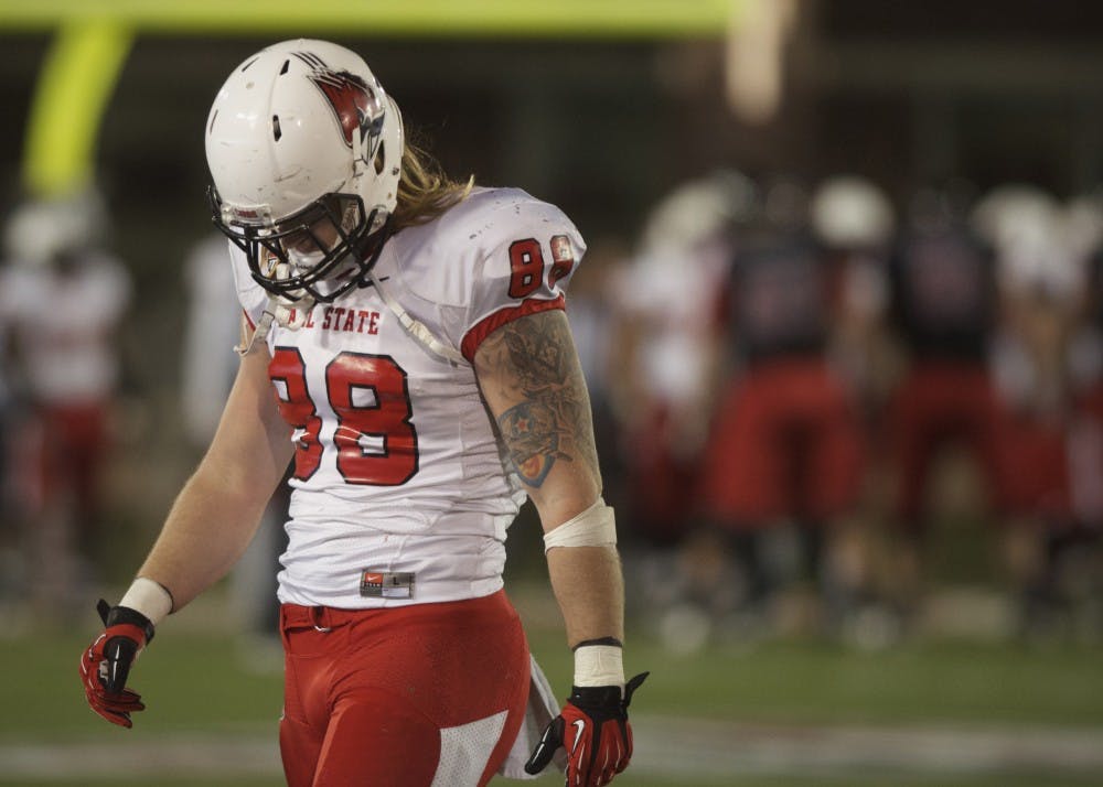 Ball State senior tight end Zane Fakes exits the field after a Northern Illinois interception in the final minutes of play Wednesday at Huskie Stadium. The Cardinals dropped the game to the Huskies 48-27. DN PHOTO MARCEY BURTON