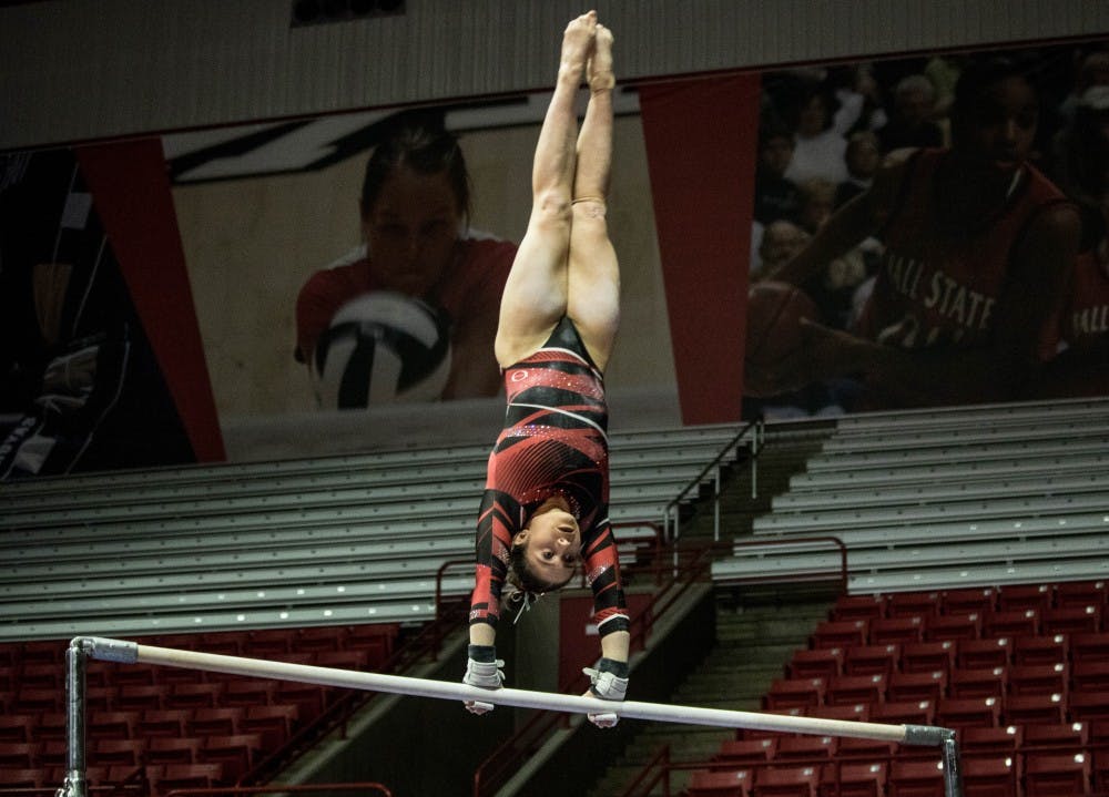 <p>Junior Kaitlyn Menzione ties for second place on the bars against Bowling Green at John E. Worthen Arena Feb. 11. Menzione got a 9.825 score and went on to claim the all-around title of the meet with a 38.4. &nbsp;<strong>Rebecca Slezak, DN File</strong></p>