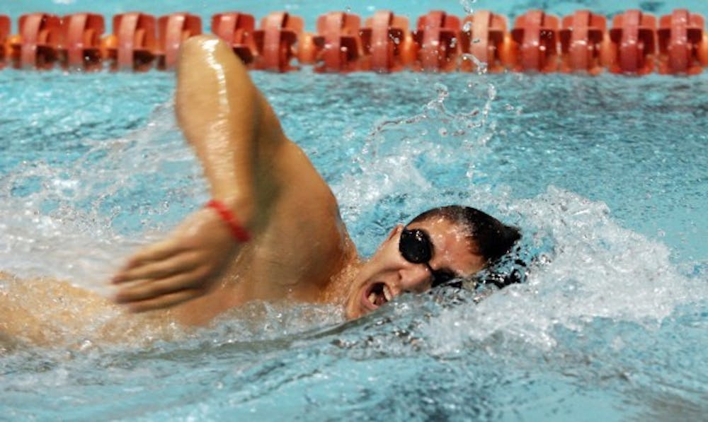 Senior Josh Young swims in the men's 800 yard freestyle relay on Saturday. DN PHOTO CATHERINE THOMPSON