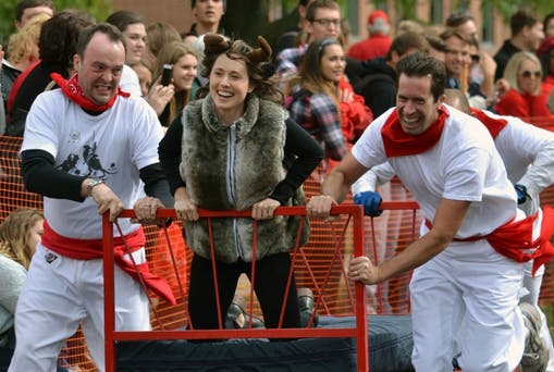 The Spanish faculty members race down Riverside during the Bed Races. DN PHOTO MAGGIE KENWORTHY