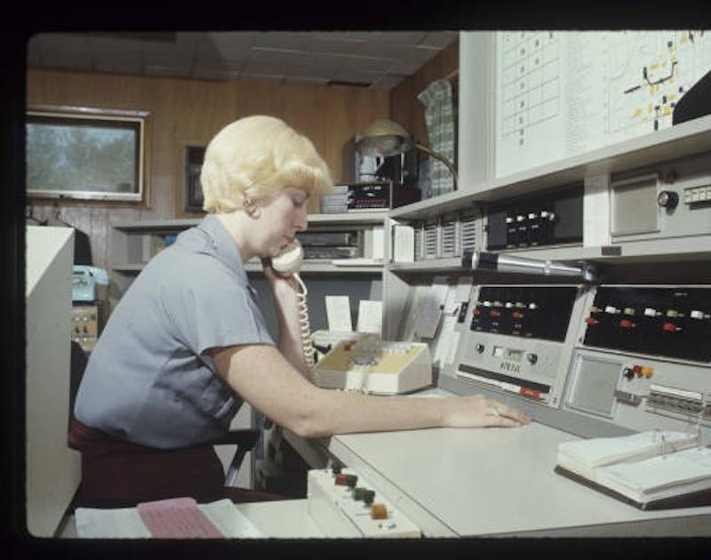 A former UPD dispatcher answers phone calls and alerts officers in August 1976. Digital Media Repository