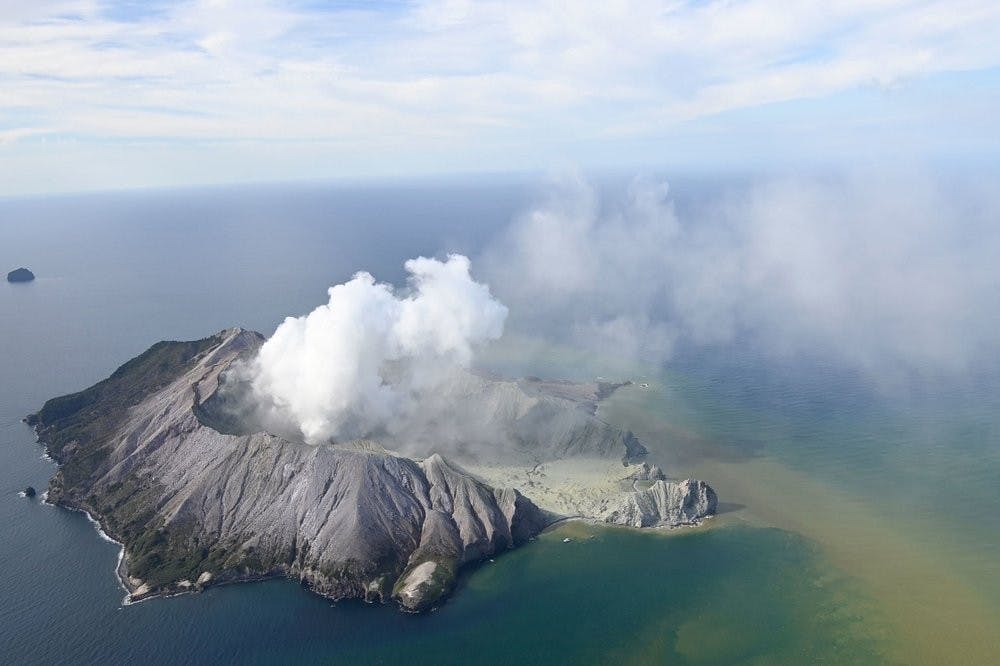 This aerial photo shows White Island after its volcanic eruption in New Zealand Monday, Dec. 9, 2019. The volcano on a small New Zealand island frequented by tourists erupted Monday, and a number of people were missing and injured after the blast. (George Novak/New Zealand Herald via AP)