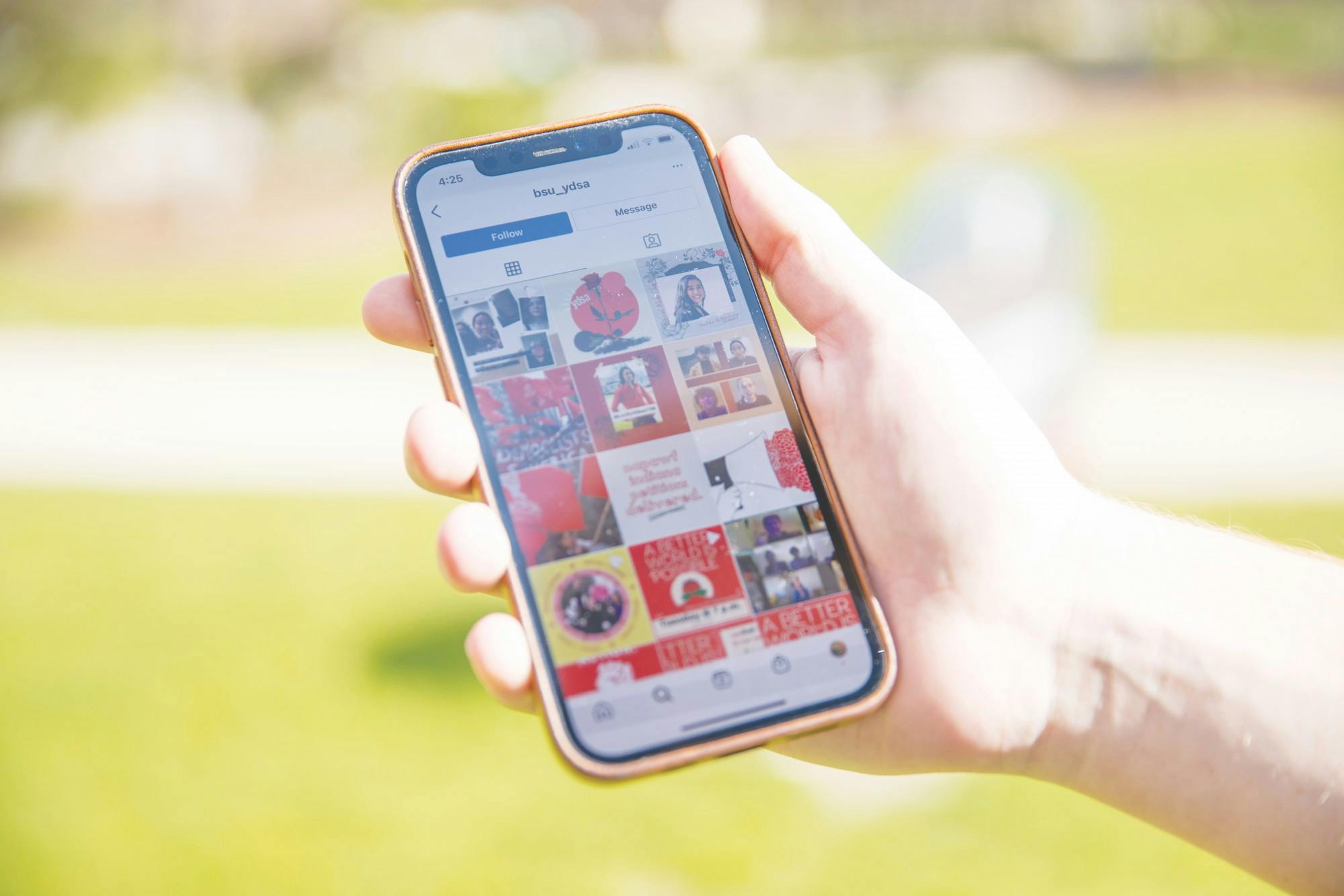 The Ball State Young Democratic Socialists of America’s Instagram page is pulled up on a phone March 31, 2021, outside of the Atrium. The new political organization has used social media for outreach early in its development. Jaden Whiteman, DN Illustration