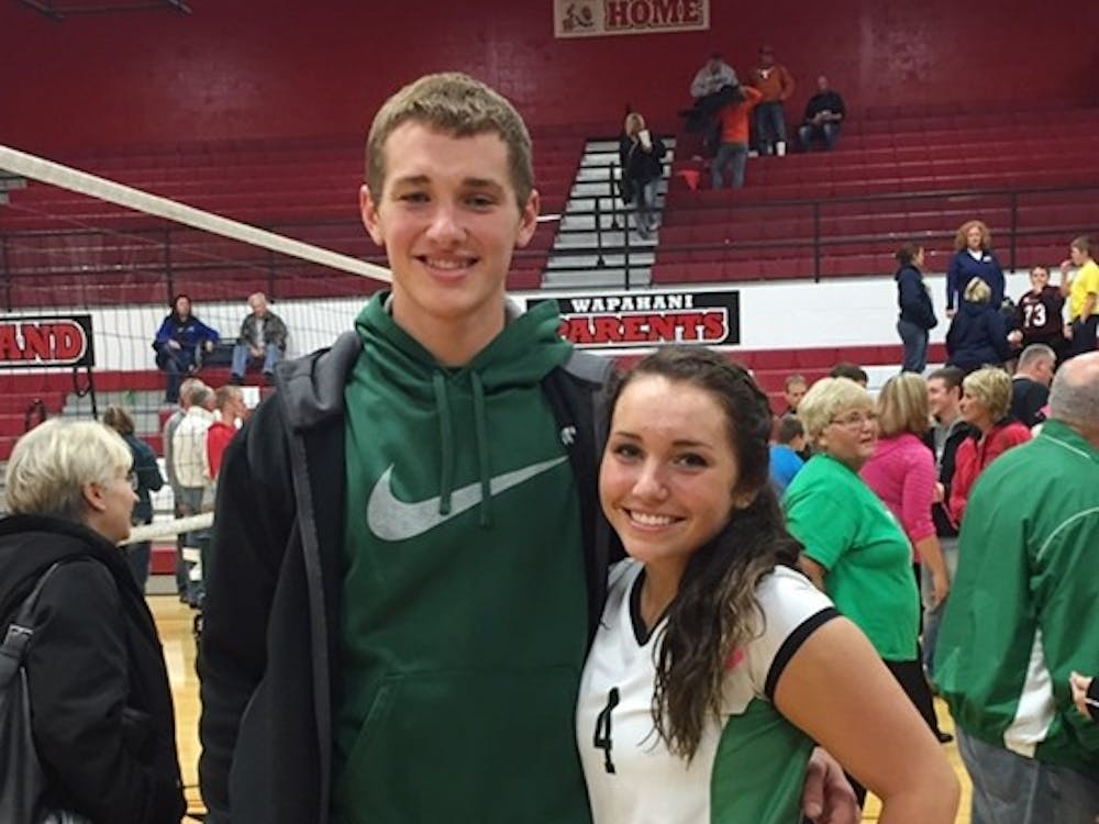 Ball State quarterback Riley Neal and his sister, Rhyen, pose for a photo following a Yorktown volleyball match at Wapahani.&nbsp;Rhyen and the Tigers play in the 3A state championship Saturday at Worthen Arena. The pair share a funny, competitive relationship at home. PHOTO PROVIDED BY RHYEN NEAL