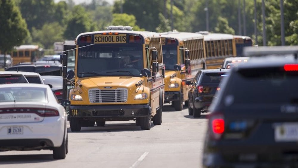Empty school buses leave after a shooting at Noblesville West Middle School in Noblesville, Ind., on Friday, May 25, 2018. A male student opened fire at the suburban Indianapolis school wounding another student and a teacher before being taken into custody, authorities said. AP Photo&nbsp;