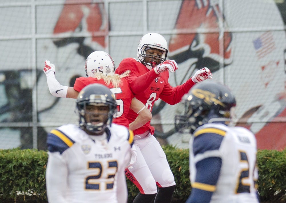 Senior wide receiver Jordan Williams celebrates with sophomore wide receiver Corey Lacanaria after getting a touchdown during the game against Toledo on Oct. 2 at Scheumann Stadium. DN PHOTO BREANNA DAUGHERTY