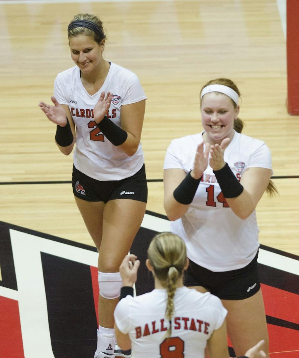 Members of the women's volleyball team celebrate after getting a point in the second game of the Active Ankle Tournament against Belmont on Aug. 28 at Worthen Arena. DN PHOTO BREANNA DAUGHERTY