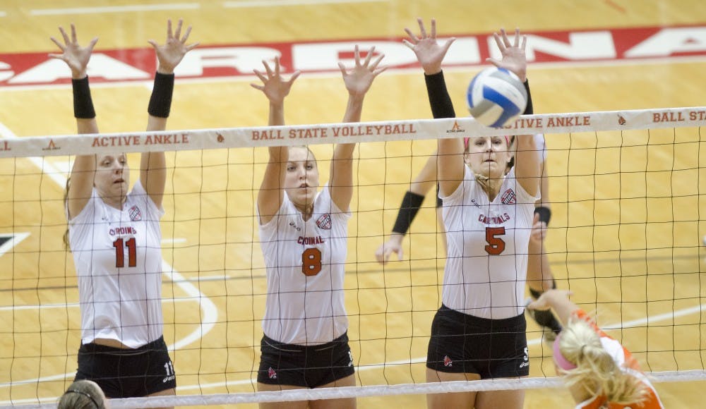 Jacqui Seidel, Mindy Marx and Kylee Baker set up a three-person defensive wall against Bowling Green State University's offense Oct. 25 at Worthen Arena. Bowling Green would take Ball State 3-1. DN PHOTO COREY OHLENKAMP