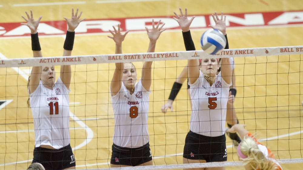 Jacqui Seidel, Mindy Marx and Kylee Baker set up a three-person defensive wall against Bowling Green State University's offense Oct. 25 at Worthen Arena. Bowling Green would take Ball State 3-1. DN PHOTO COREY OHLENKAMP