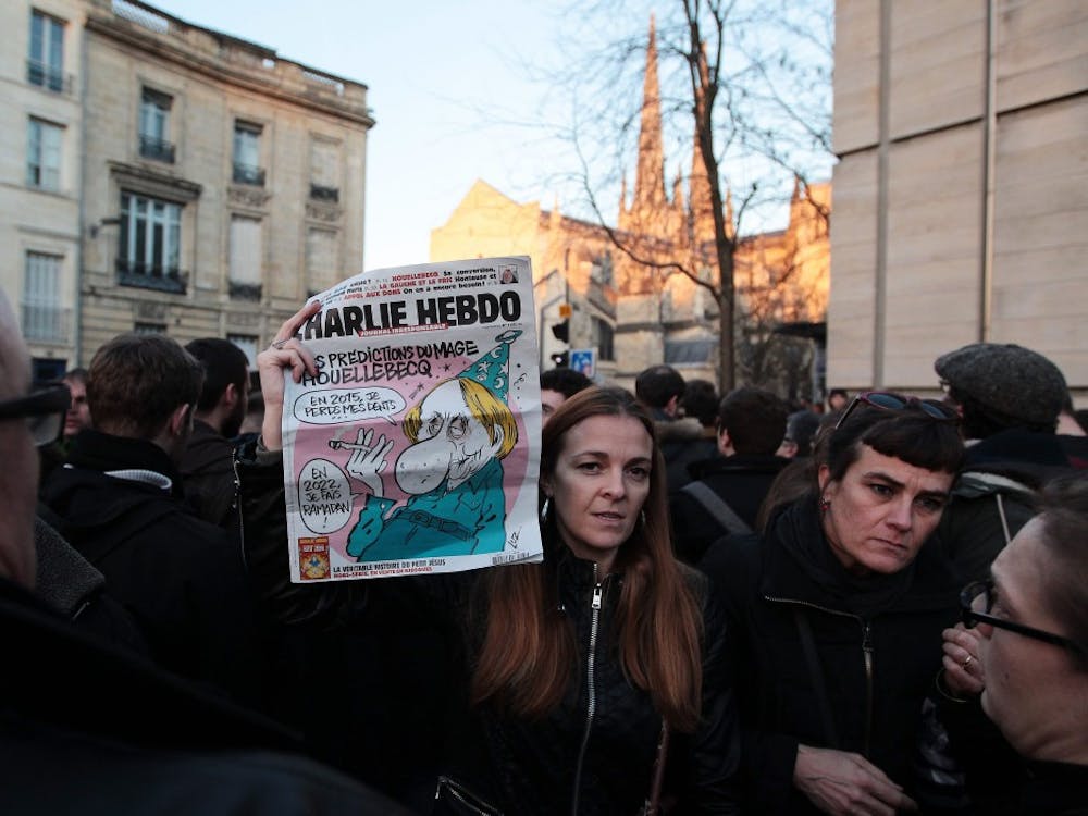People hold up tributes to the victims of the Charlie Hebdo shooting on Jan. 7 during a 1-minute silence in Bordeaux, France, in remembrance of those killed and wounded in the deadly attack in Paris on Wednesday. Gunmen killed 12 people at the Paris office of French satirical magazine Charlie Hebdo in an apparent militant Islamist attack. Four of the magazine
