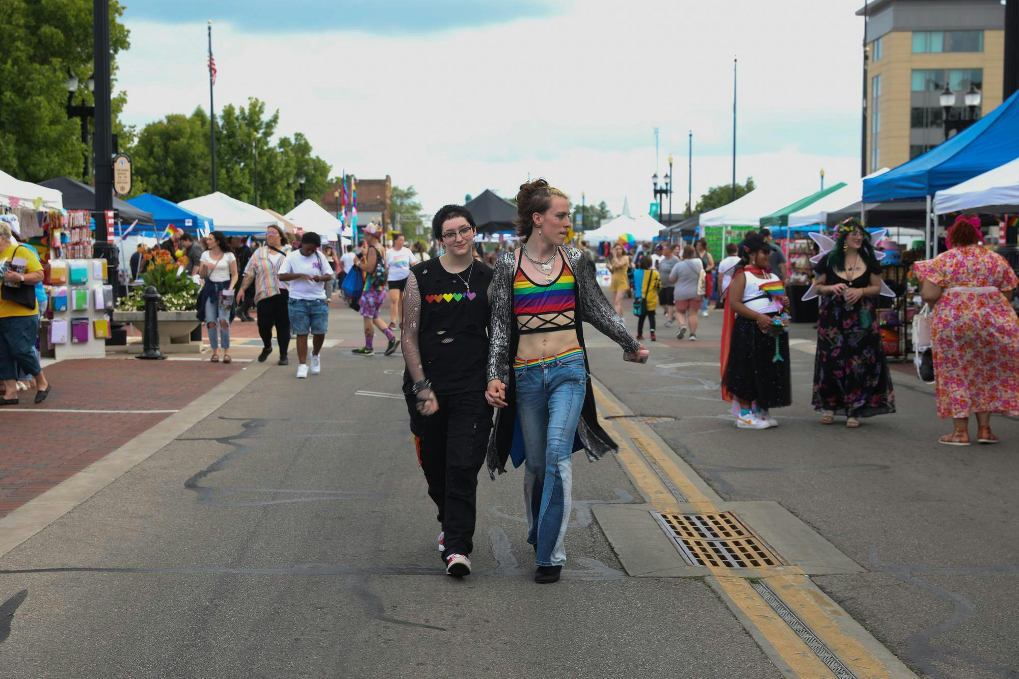 Two partners walk hand in hand during Muncie Pride Aug. 31 at Cannon Commons Park. Muncie Pride takes place every year in August. Jessica Velez, DN
