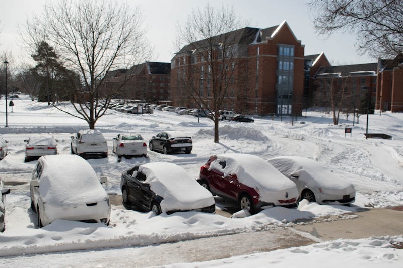 A group of cars sit covered in snow outside Studebaker West Hall Feb. 4. The Indiana Department of Transportation and National Weather Service advised drivers to stay off the road for nonessential purposes during the course of the winter storm. Joey Sills, DN