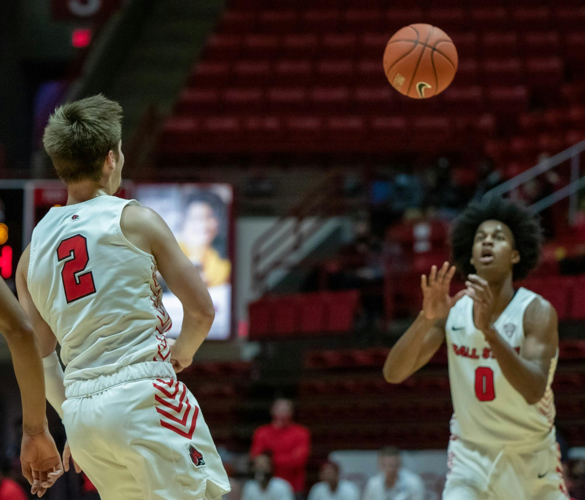 Sophomore guard Luke Bumbalough passes the ball to redshirt junior forward Miryne Thomas Feb. 2, 2021, at John E. Worthen Arena. Bumbalough played 32 minutes against the Buffalo Bulls. Jaden Whiteman, DN