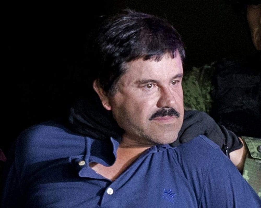 In this Jan. 8, 2016 file photo, drug lord Joaquin "El Chapo" Guzman is made to face the media in Mexico City as he is escorted by Mexican soldiers following his recapture six months after escaping from a maximum security prison. The notorious Mexican drug lord was convicted of drug-trafficking charges, Tuesday, Feb. 12 2019, in federal court in New York. (AP Photo/Eduardo Verdugo, File)