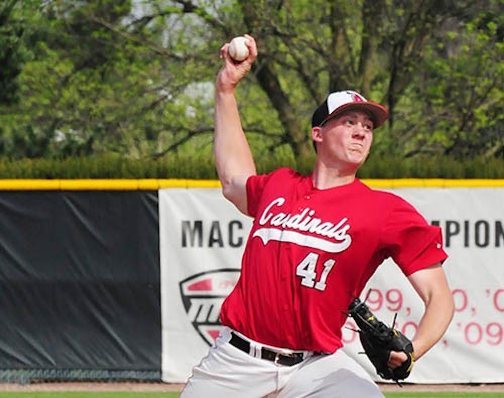Right-handed pitcher Scott Baker throws a pitch in the game against Indiana Tech last season. The Cardinals will play the Zips Friday at 3 p.m. DN FILE PHOTO COREY OHLENKAMP