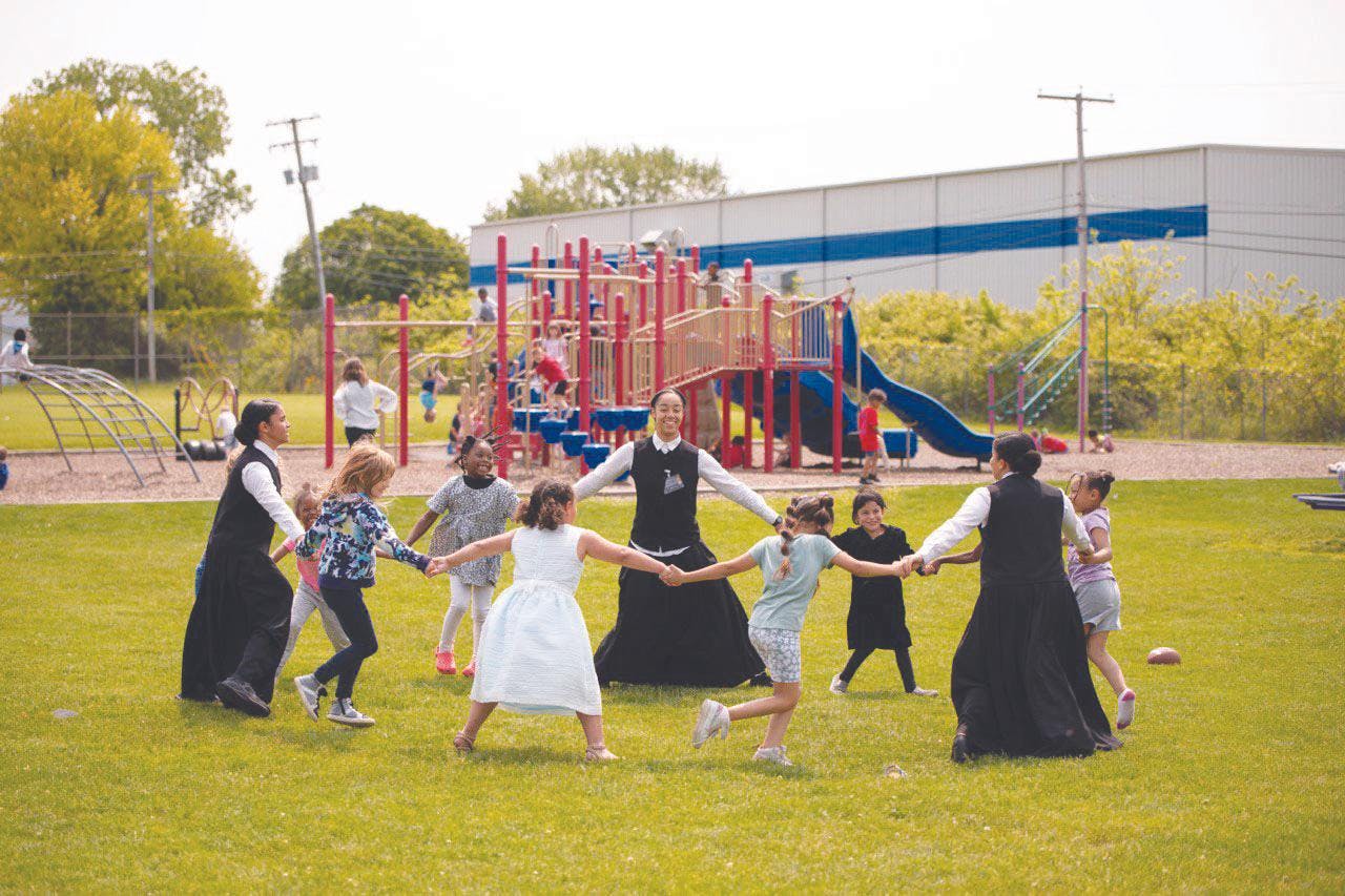 Educational Activists play a game with elementary students at South View Elementary School in Muncie, Indiana, May 18, 2023. The activists help teach students how to read and write in small groups. Real Black Excellence, Photo Provided. 