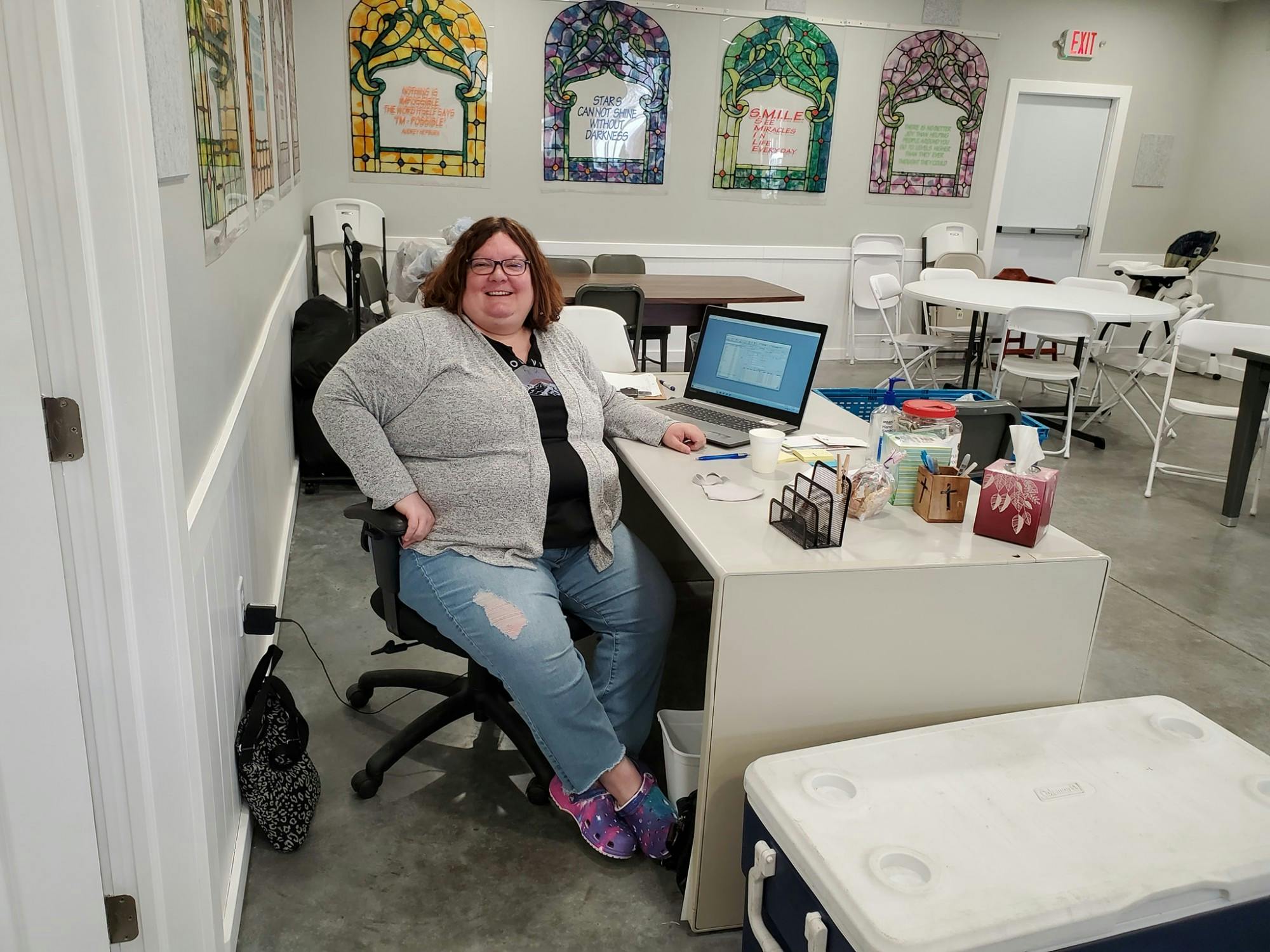 Toni Werner sits at a desk at Warm a Heart ministry in Waterloo. Werner is a 1999 Ball State alumna who taught for 23 years before becoming director of the ministry. Warm a Heart ministry, Photo Courtesy