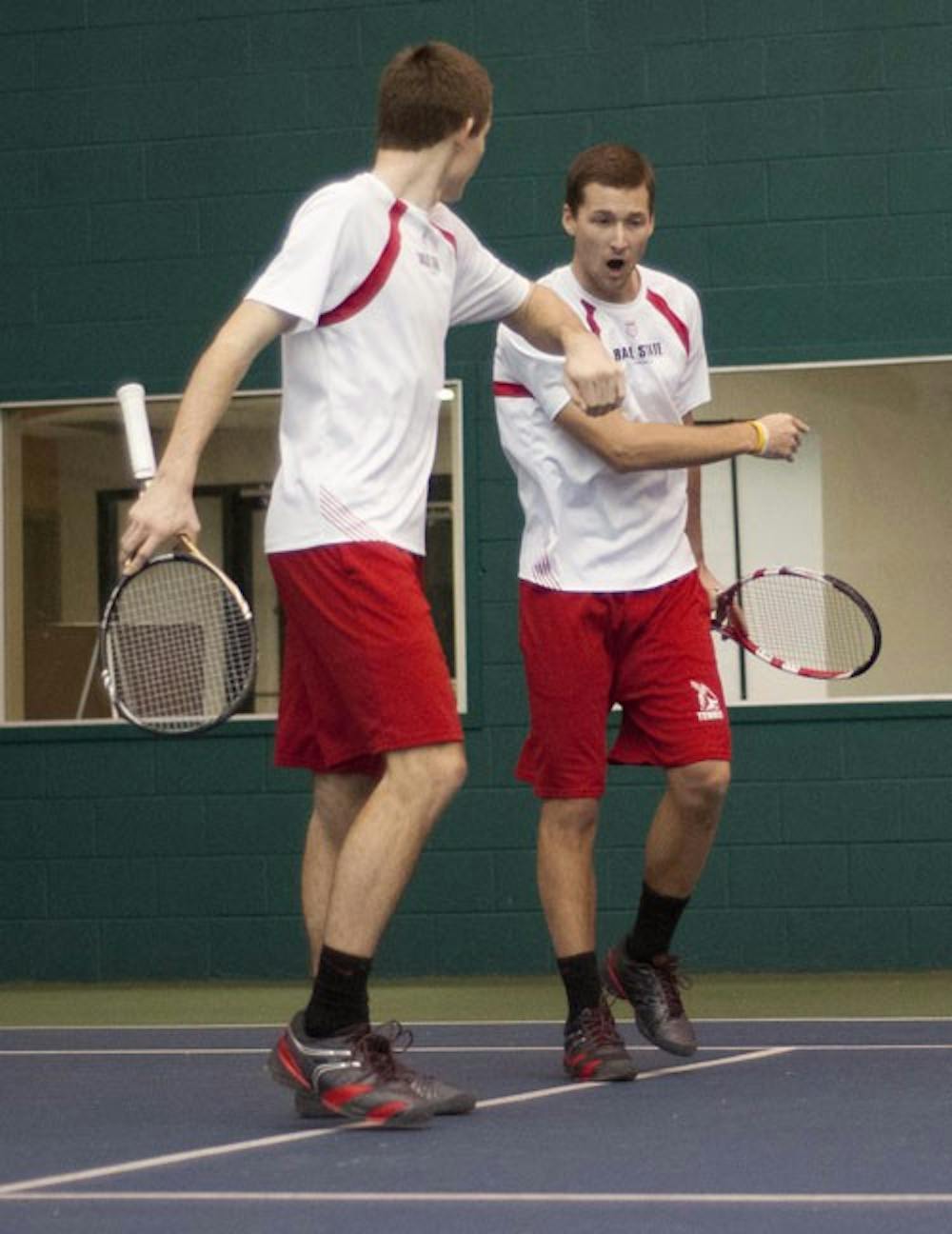 Senior Dalton Albertin, right, and sophomore Ray Leonard congratulate each other after winning a doubles game. DN PHOTO BOBBY ELLIS