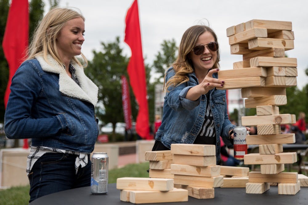 Kristen Olson and Taylor West play Jenga in Charlie Town Sept. 22, 2018, before Ball State played Western Kentucky in football. Charlie Town is a tailgating opportunity, and takes place before every home football game. Eric Pritchett, DN File