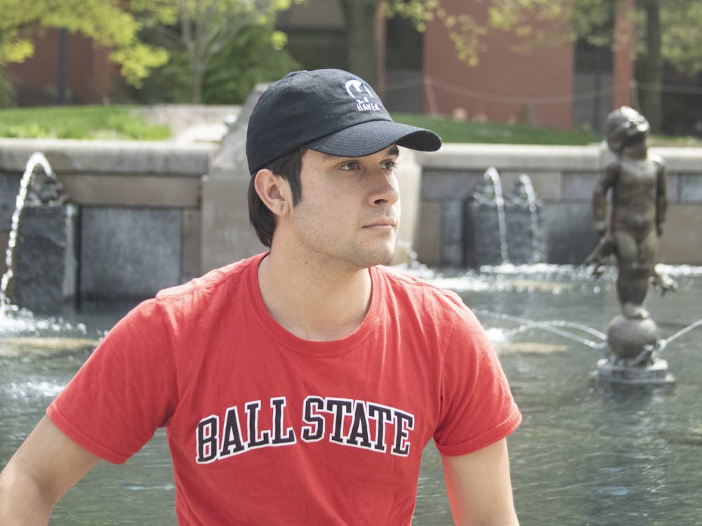 Second-year journalism major Zach Gonzalez poses in front of Frog Baby Fountain April 20, 2023. - Grayson Joslin, DN