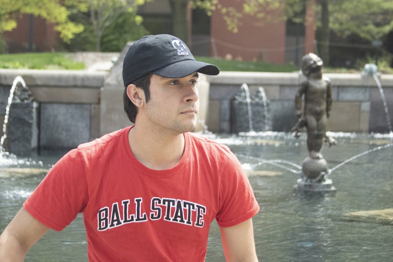 Second-year journalism major Zach Gonzalez poses in front of Frog Baby Fountain April 20, 2023. - Grayson Joslin, DN