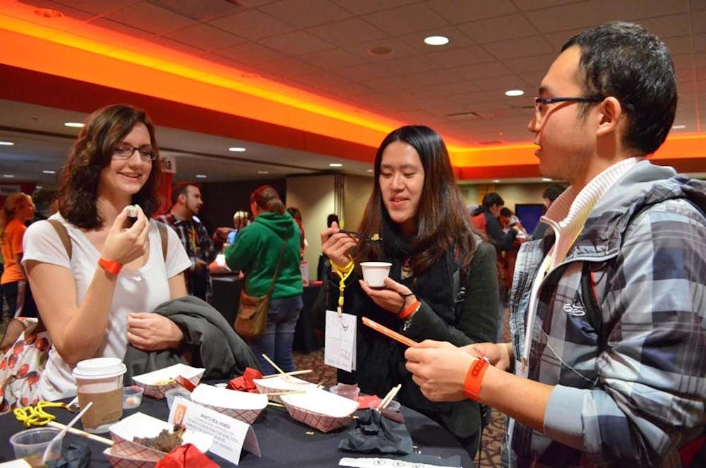 Senior Megan Roche, graduate student Artemis Yu Zhu and freshman Qiuhan Li taste Asian cuisine at The Amazing Taste on Thursday at the L.A. Pittenger Student Center. DN PHOTO SHAE GIST