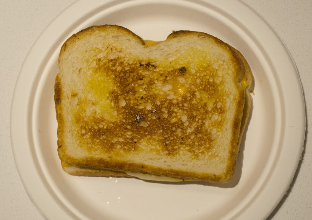 In the Kinghorn lobby on Dec. 3, resident advisors cooked grilled cheese sandwiches. The money go to help A Better Way with Christmas presents.&nbsp;DN PHOTO BREANNA DAUGHERTY