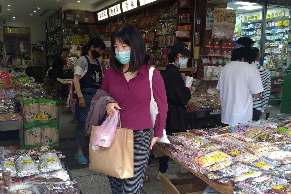 People wearing face masks to help curb the spread of the coronavirus shop at a market in Taipei, Taiwan, Monday, Oct. 19, 2020. (AP Photo/Chiang Ying-ying)