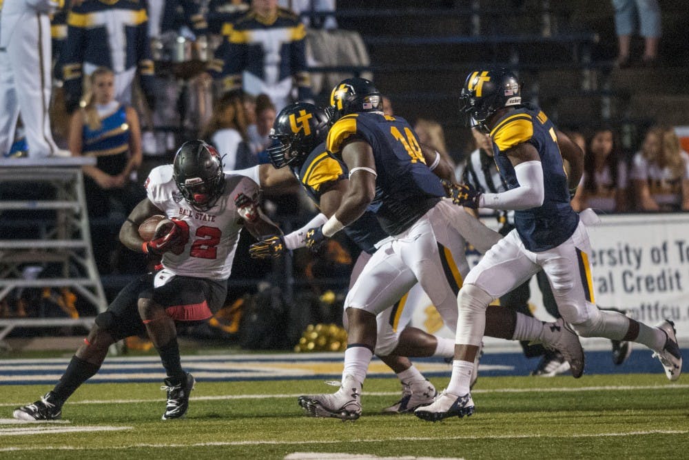 Senior running back Jahwan Edwards attempts to push past the Toledo defense during the game against Toledo at the Glass Bowl on Sept. 20. DN PHOTO JONATHAN MIKSANEK