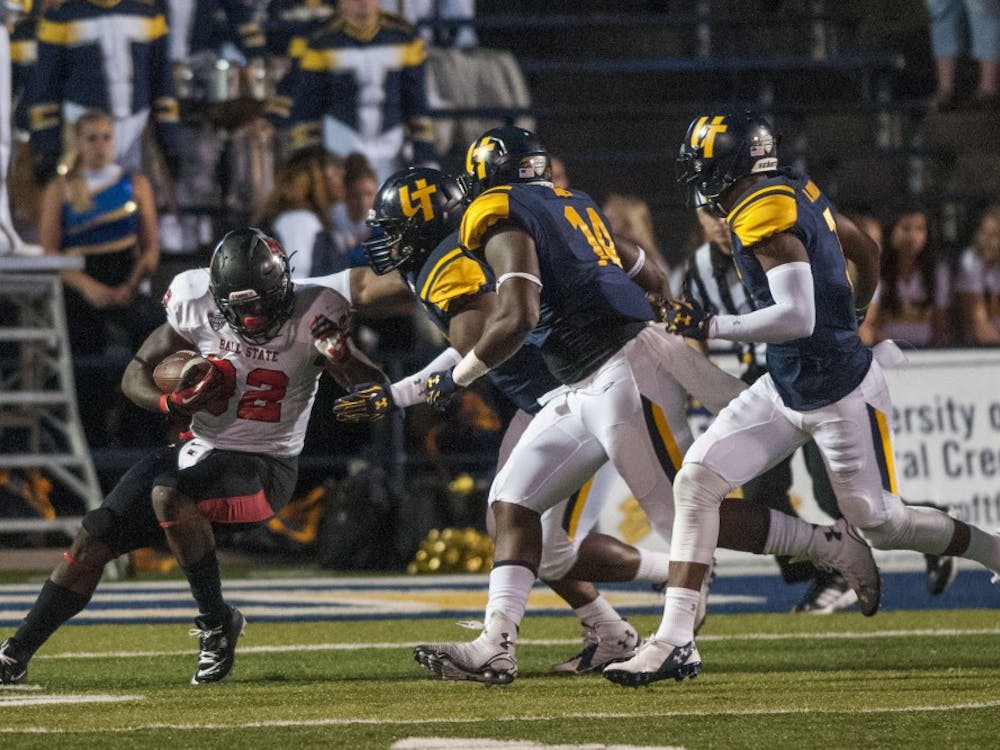 Senior running back Jahwan Edwards attempts to push past the Toledo defense during the game against Toledo at the Glass Bowl on Sept. 20. DN PHOTO JONATHAN MIKSANEK