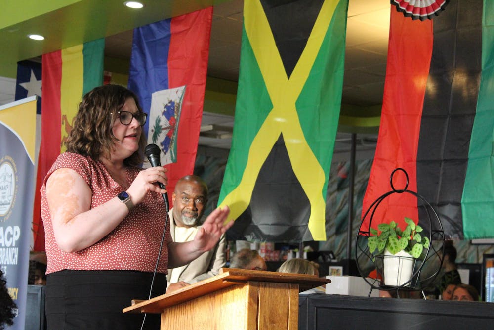 <p>Chair of Muncie Resists Sarah Vitale stands at the podium during the Circuit 2 judicial forum at Legacy Village restaurant on Sept. 12. She asked the candidates about the effectiveness of the Juvenile Detention Alternatives Initiative (JDAI). Meghan Braddy, DN</p>