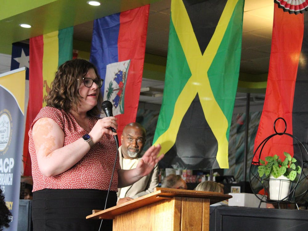 Chair of Muncie Resists Sarah Vitale stands at the podium during the Circuit 2 judicial forum at Legacy Village restaurant on Sept. 12. She asked the candidates about the effectiveness of the Juvenile Detention Alternatives Initiative (JDAI). Meghan Braddy, DN