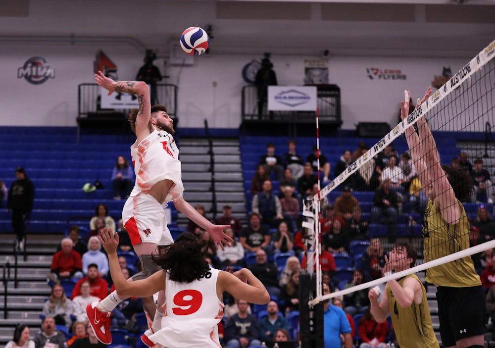 Graduate Student middle blocker Wil McPhillips spikes the ball against Purdue Fort Wayne March 23 at Gates Center in Fort Wayne, Indiana. McPhillips scored seven points in the game. Mya Cataline, DN