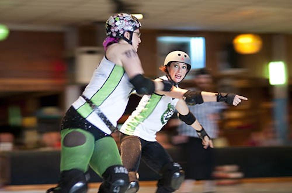 Members of The Derby Dames, ”Philly Cheezeskate” and “Bonan Contention,” skate during a jam in September. The Dames will be skating again Saturday night at Gibson’s Skating Rink at 7:30 p.m. The DN FILE PHOTO JONATHAN MIKSANEK