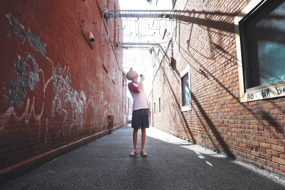 <p>Stevie Hahn, known online as "Ray Toffer," poses for a portrait in Dave's Alley in downtown Muncie Aug. 17. Jacy Bradley, DN</p>