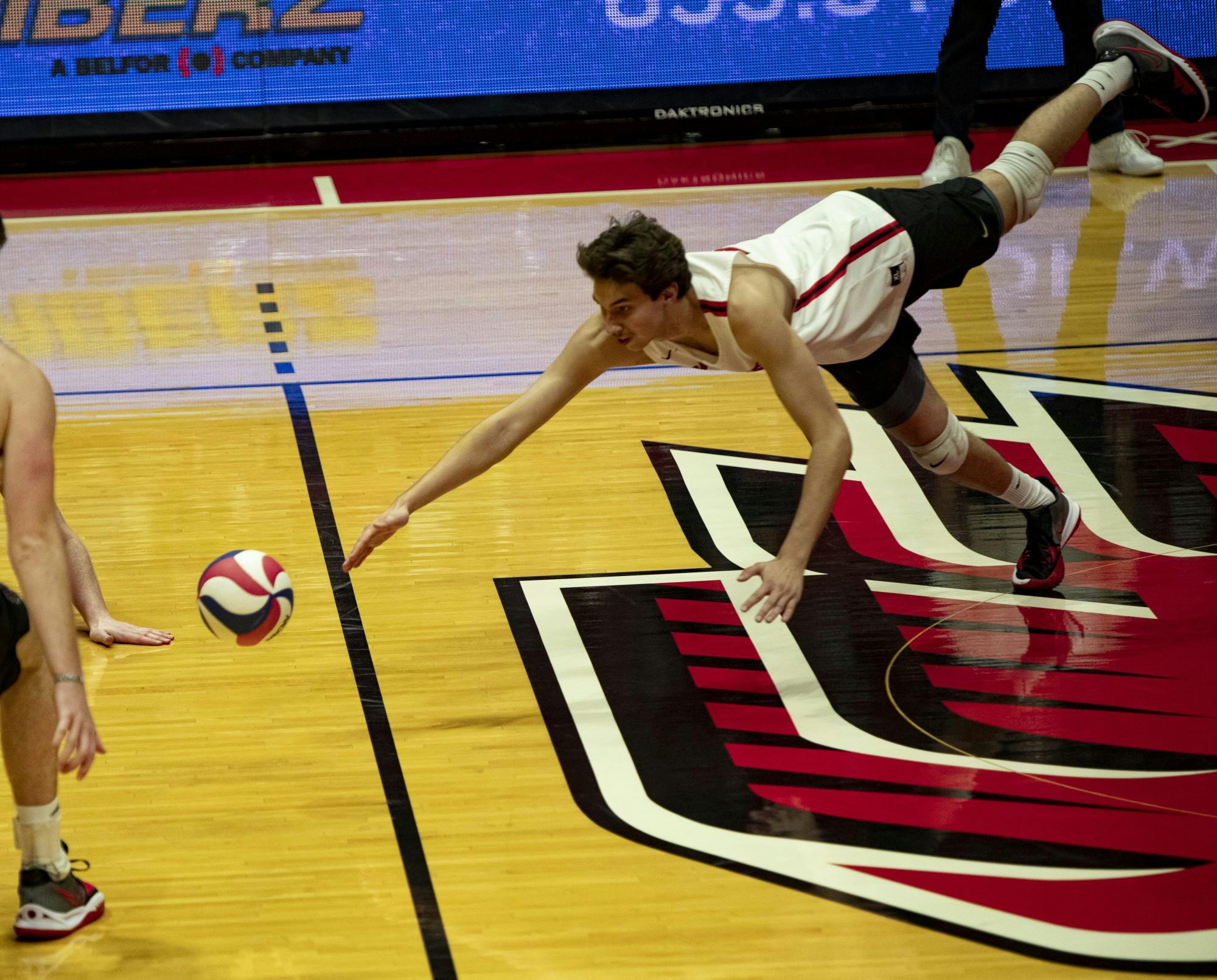 Senior outside hitter Nick Martinski (22) dives for the ball against Purdue Fort Wayne at Worthen Arena Feb. 17. The Cardinals had 73 kills against the Mastodons. Jacy Bradley, DN