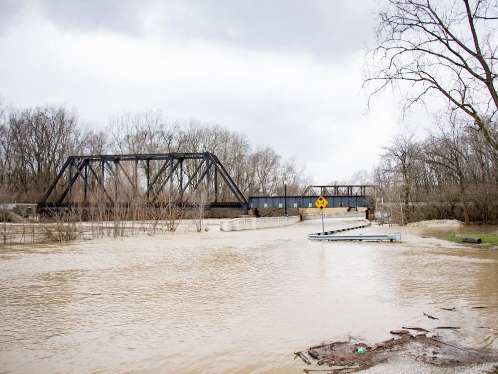 East McCulloch boulevard floods during a day of heavy rain fall April, 4, 2018, in Muncie. The White River began to dam under bridges from debris which cause trails and roads to flood. Eric Pritchett, DN
