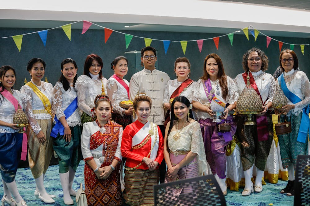 <p>Members of the Royal Thai Consulate pose for a photo with Sakdidach (Joseph) Nobpatsorn (center) at the Songkran festival April 12 at Emens Auditorium. Nobpatsorn is the president of Global Harmony student organization. Andrew Berger, DN</p>