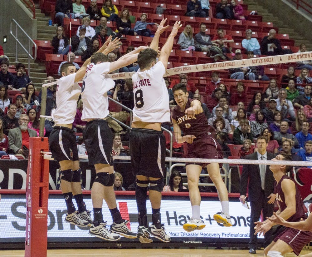 Sophomore Mike Scannell, freshman Matt Walsh and junior Hiago Garchet jump to block the ball during the game against Loyola on March 28 at Worthen Arena. DN PHOTO ALAINA JAYE HALSEY