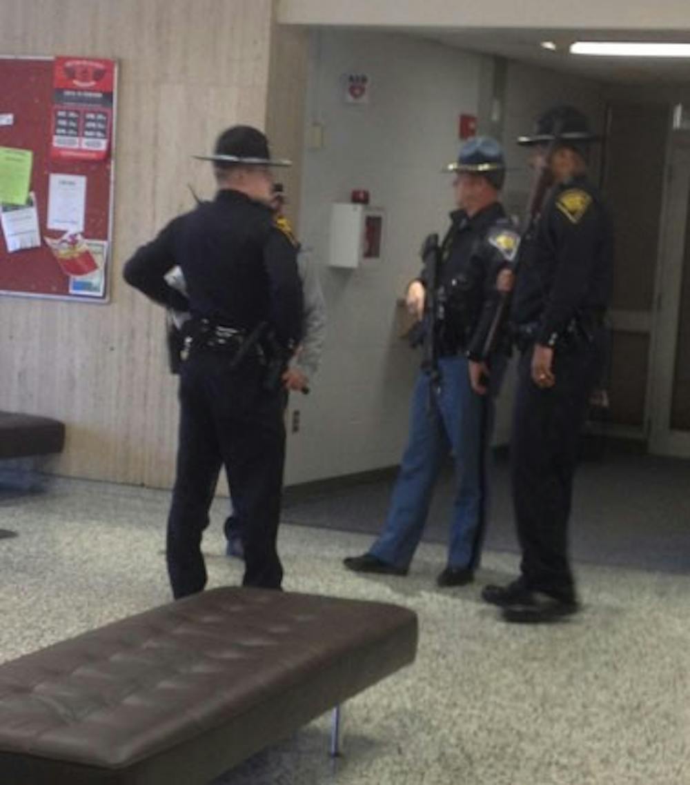 Police stand in Eskenazi Hall on the campus of IUPUI. Officers are searching every building after reports of a gunman near the corner of Barnhill Drive and Vermont Street.
PHOTO COURTESY OF FREDRICK MILLER