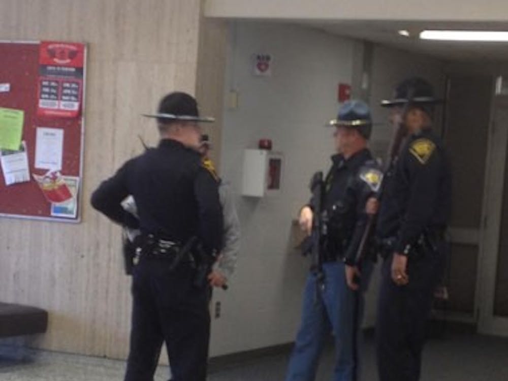 Police stand in Eskenazi Hall on the campus of IUPUI. Officers are searching every building after reports of a gunman near the corner of Barnhill Drive and Vermont Street.
PHOTO COURTESY OF FREDRICK MILLER
